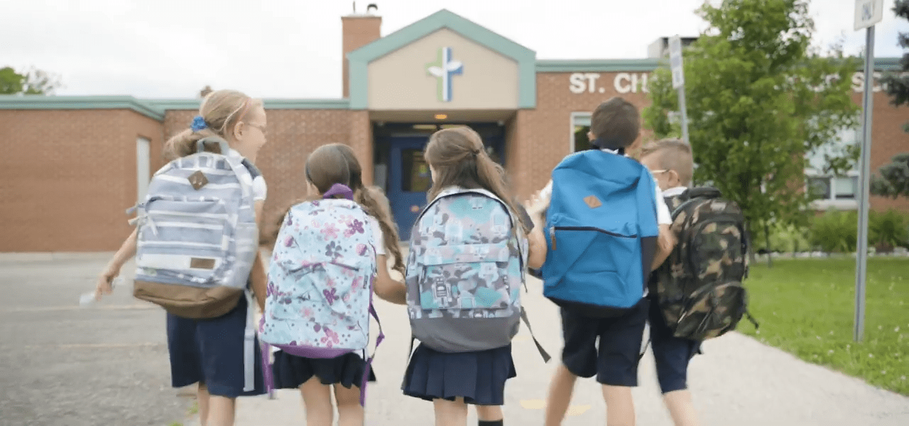 children walking to school with backpacks on