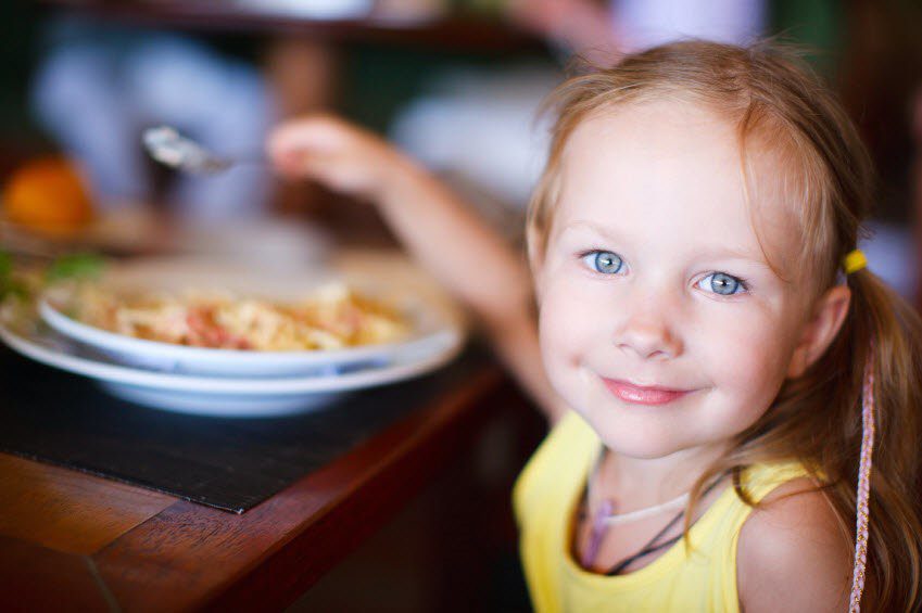 child eating food at the table