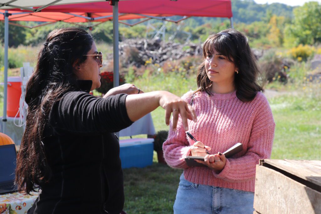 Ella Larosa interviewing a staff member at the Garden Hub Open House